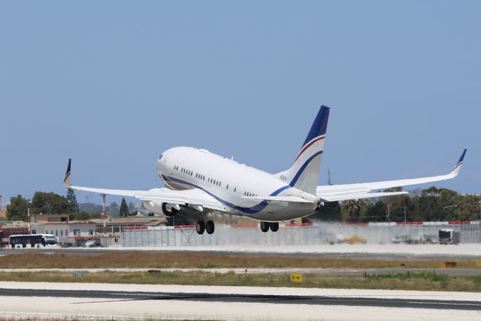 A commercial airplane takes off from a runway on a clear day, showcasing aviation and travel concepts.