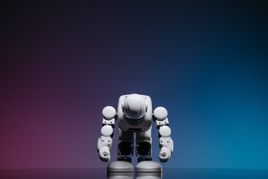 White robot in a bowing pose against a gradient studio background.