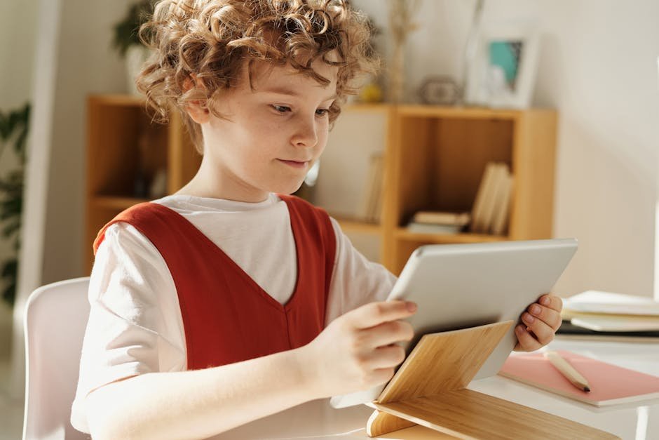 Young child using tablet for learning in a bright home setting, showcasing modern education.