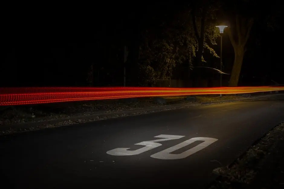 A long exposure night street scene in M&ouml;nchengladbach showcasing vibrant car light trails.