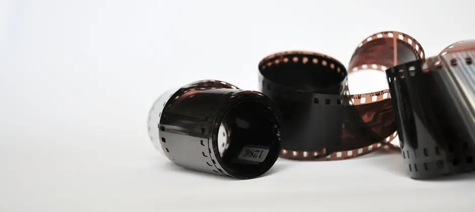 Two vintage photo film reels against a white backdrop, showcasing analog photography equipment.