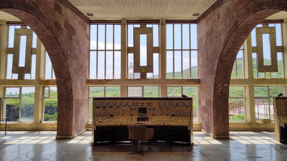 Retro control room interior with vintage equipment and scenic view through large windows in Armenia.