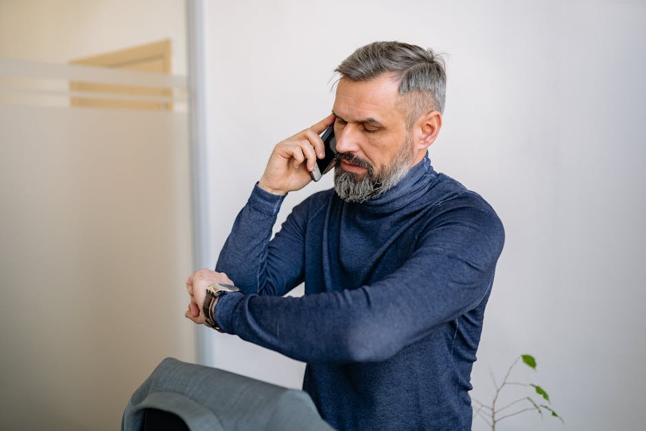 A frustrated patient stares at a phone with no missed calls as a doctor's office building looms in the background never get doctor call back
