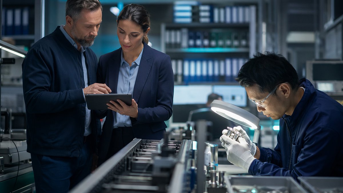 Factory manager reviewing compliance charts under state AI regulation pressure