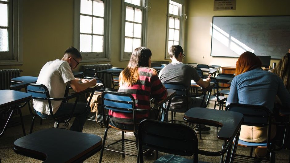 A student at Brown University stares at a computer screen showing a 50% score drop linked to an AI cheating scandal