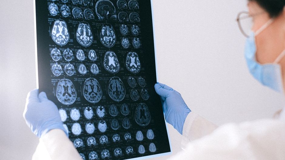 A diagram shows how NEvo creates custom videos to activate specific brain regions in the visual cortex using AI-generated videos brain activation