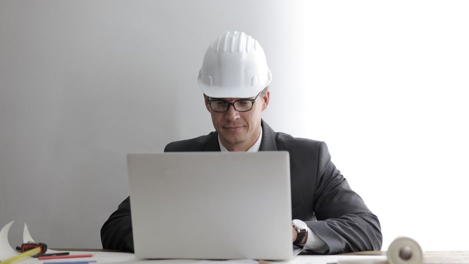 A quality manager reviews code with confusion as AI-generated solutions fail to meet standards in software development
