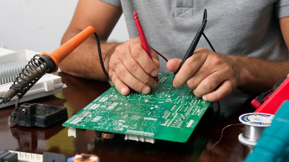 A group of professionals examining a sleek AI dev kit hardware setup on a table amidst charts and data visuals
