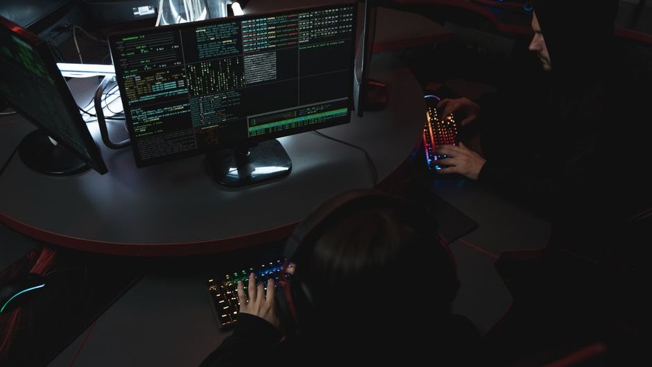 Boko Haram operatives using AI technology to plan attacks and enhance operational strategies in a dimly lit room