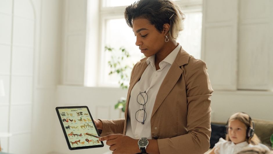 A student uses a real-time AI tutor on a tablet while working on math problems in a classroom setting