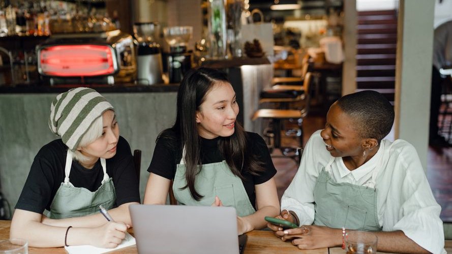 A cluttered AI-generated menu with mismatched fonts and colors highlights common mistakes small businesses make in redesigns