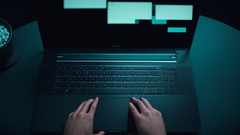 A writer types on a laptop while a glowing AI interface hovers nearby showing text suggestions in the writing process