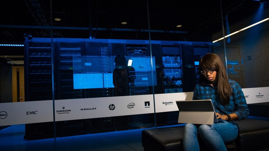 Glowing red lines of malicious code breach server racks linked to AI lab liability