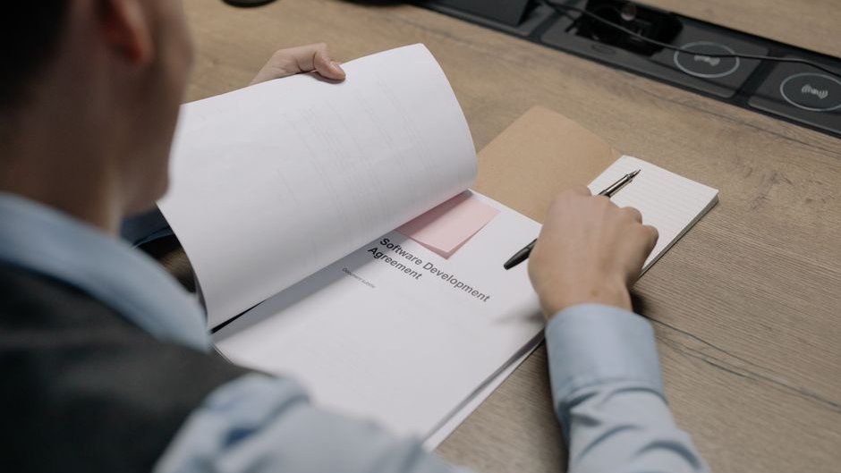 An executive reviewing contract terms on a screen highlighting AI lab liability provisions