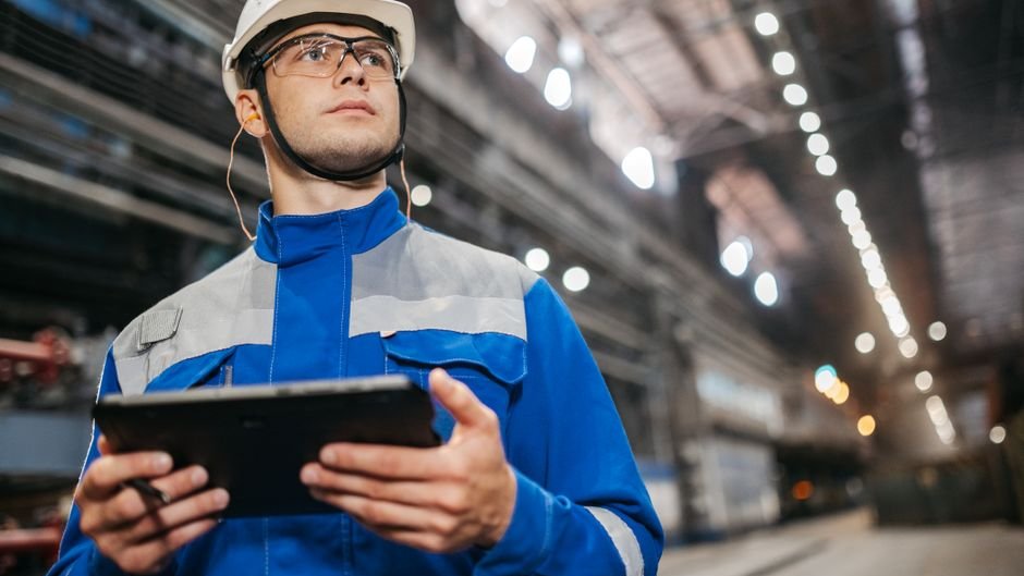 Factory engineers troubleshoot a failed robotic assembly line impacted by AI lab overconfidence