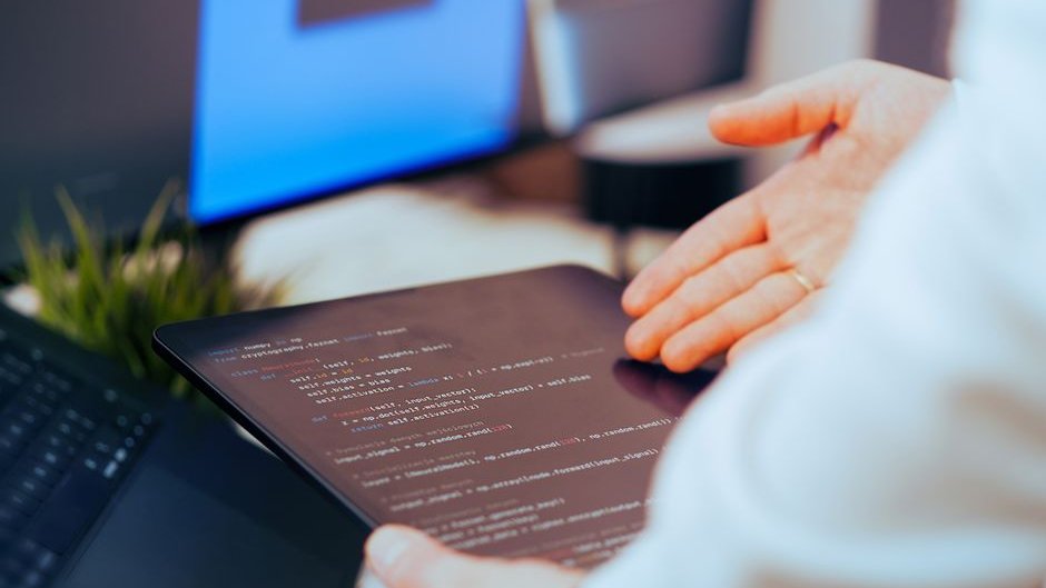 A developer inspecting streams of fast AI generated code during AI software engineering reviews