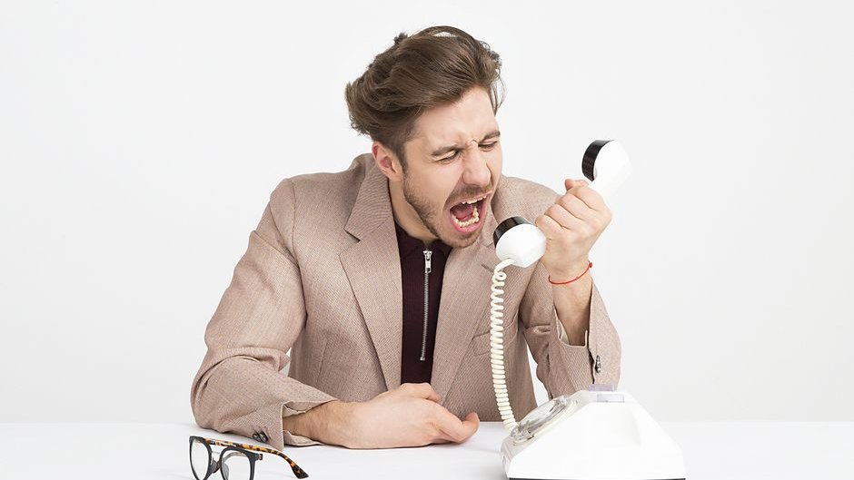 Stressed business manager looking at negative online reviews caused by generative AI backlash