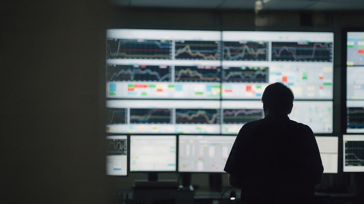 Quality engineer on factory floor reviewing CAPA records in a knowledge AI platform